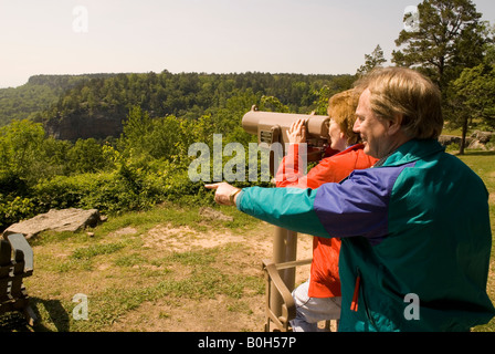 Caucasian couple (50-55) enjoying the view through a telescope from Mather Lodge at Petit Jean State Park, Arkansas, USA. Stock Photo