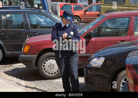 Shropshire UK May Female traffic warden waiting for parking fine details to be printed from hand held computer Stock Photo