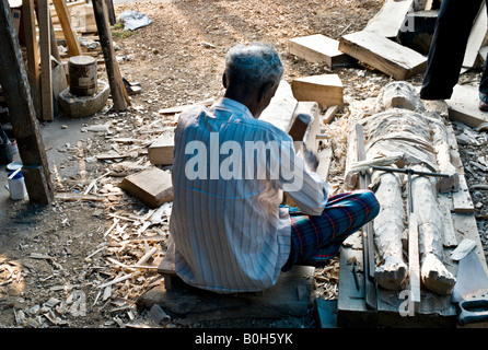 INDIA CHAMBAKKULAM KERALA Elderly Indian woodcarver carving statue of Jesus Christ Stock Photo