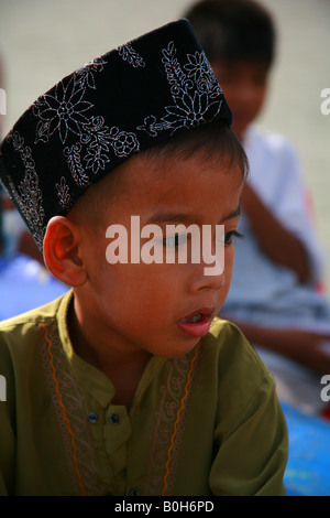 koh samui, little muslim boy outside mosgue on eid ul fitr festival Stock Photo