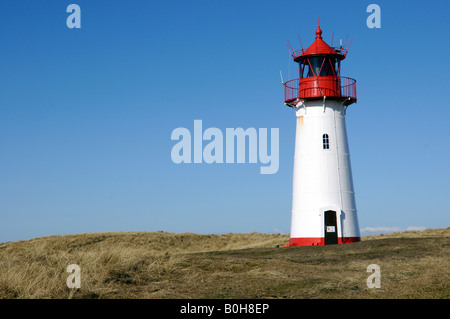 Lighthouse painted red a white standing on grassy hill, Ellenbogen, Sylt Island, North Frisian Islands, Schleswig-Holstein, Ger Stock Photo