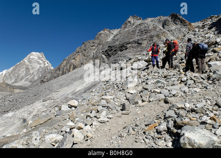 Trekking group hiking over boulder field to Cho La Pass (5330 m), Sagarmatha National Park, Khumbu Himal, Himalayas, Nepal, Asia Stock Photo