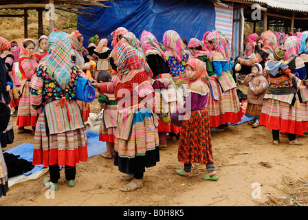 Flower Hmong, Mong, or Miao women and children in traditional dress at a market, Ha Giang Province, North Vietnam Stock Photo