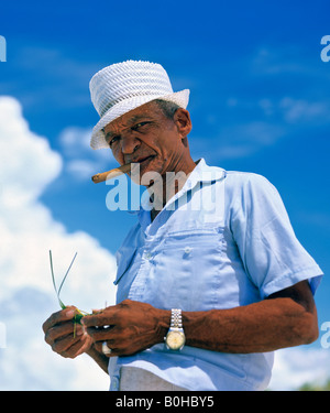 Man smoking a Cuban cigar, clouds, Cuba Stock Photo