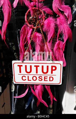 Closed sign hanging in the shop window of a fashion boutique in the Netherlands Stock Photo