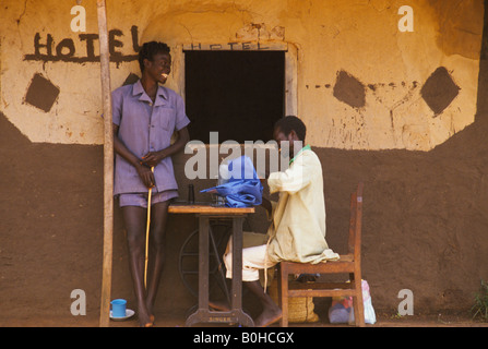 A tailor working on a sewing machine outside a hotel, Uganda. Stock Photo