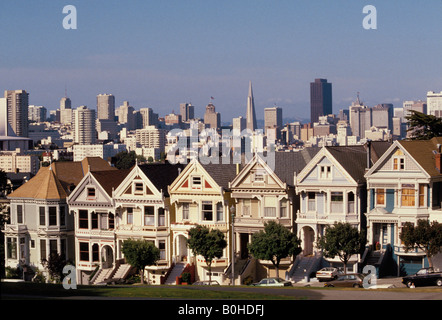 A view of the city behind 19th Century houses in Alamo Square, San Francisco, California, USA. Stock Photo