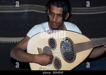 Bedouin playing the lute in a Bedouin tent, Wadi Rum, Jordan, Middle East Stock Photo