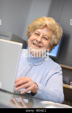 Senior woman working on a laptop Stock Photo