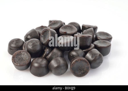 Black licorice or liquorice drops, small pile of sweets, jujubes Stock Photo