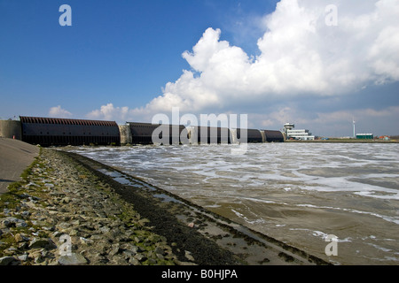 Opened floodgates at the Eider Barrage at the mouth of the Eider River into the North Sea, sea water streaming into the Eider R Stock Photo