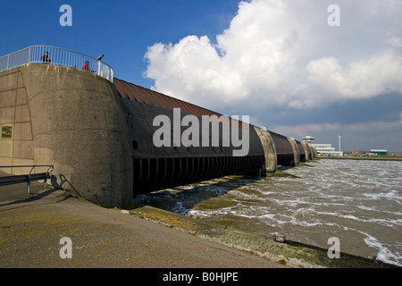 Opened floodgates at the Eider Barrage at the mouth of the Eider River into the North Sea, sea water streaming into the Eider R Stock Photo