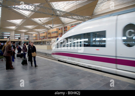 Passengers on a platform await the arriving AVE bullet or high-speed train at the Estacion de Delicias station, Saragossa or Za Stock Photo