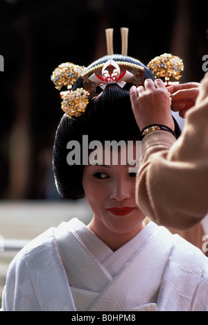 A bride getting ready to have her photograph taken on her wedding day, Tokyo, Japan. Stock Photo