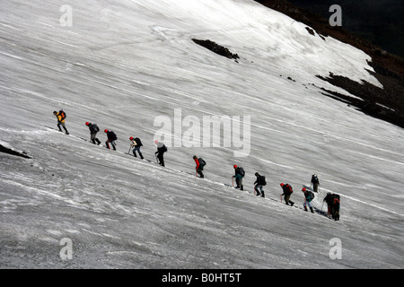 Mountain climbers climbing an ice field at the Villarrica or Rucapillán Volcano, Pucon, Chile, South America Stock Photo