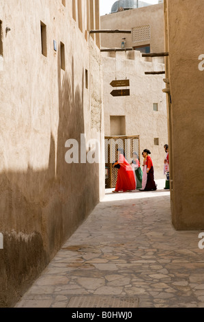 Dubai, United Arab Emirates (UAE). Street scene in al Bastakiya, a restored historic quarter of old Dubai. Girls on their way to school Stock Photo