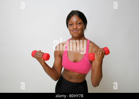 Young African American woman lifting weights, MR-4-30-08 Stock Photo