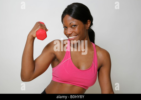 Young African American woman lifting weights, MR-4-30-08 Stock Photo