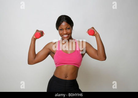 Young African American woman lifting weights, MR-4-30-08 Stock Photo
