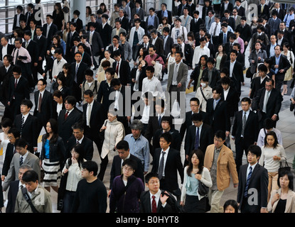 Crowd of commuters walking to work during morning rush hour in railway station in Tokyo Japan Stock Photo