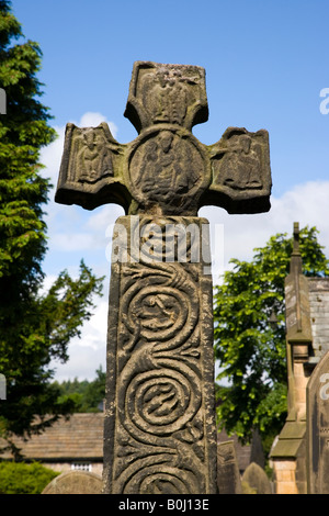 The 8th Century Celtic Cross at St Lawrences Church at Eyam in the Peak District in Derbyshire Stock Photo