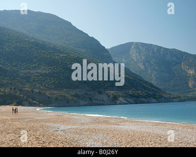 FIGURES ON BEACH AND MOUNTAINS AT BELCEKIZ, MUGLA TURKEY Stock Photo