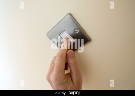 light switch being turned on Stock Photo