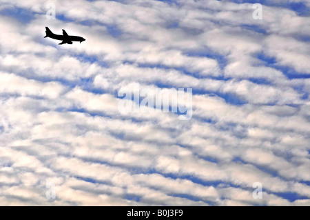 A plane makes it s decent to O Hare International Airport seen from Elmhurst IL Stock Photo