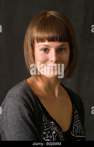 Smiling young woman with fringe studio portrait, Walsall, UK Stock Photo