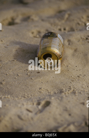 Beach litter empty been can on sand Stock Photo