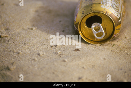 Beach litter empty been can on sand Stock Photo