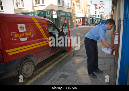Royal mail postman collecting letters street red postbox van talking Royal mail postman collecting letters street red postbox van talking