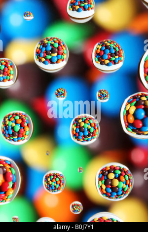 abstract background colorful candies reflected in water drops Stock Photo