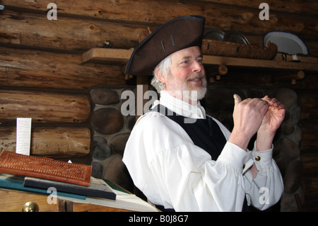 Historical re-enactment of Fur Trading Post and Fur Trader in USA & Canada in Traditional Clothing, Actor lecturing to audience Stock Photo