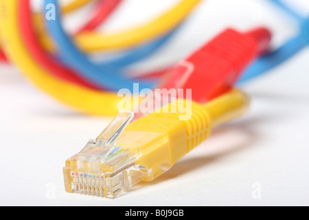 Category 5 network cables isolated on white three different colors red blue and yellow Stock Photo