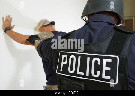 Police officer and criminal, back view Stock Photo