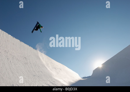 Silhouette of teenage snowboarder on  halfpipe Stock Photo