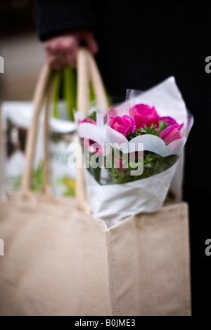 Womans hand holding a Jute shopping bag Stock Photo
