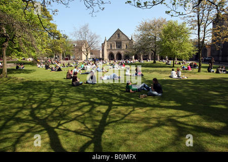 Students reading, talking and sun bathing on the lawn outside Elphinstone Hall at the University of Aberdeen, Scotland, UK Stock Photo