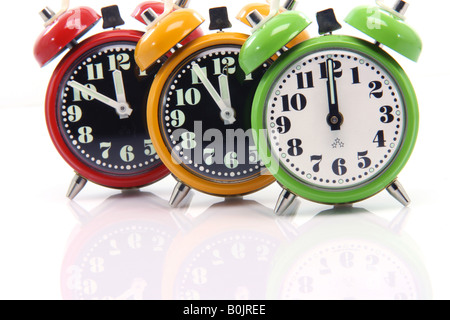 timing red yellow and green alarm clock untill twelve oclock closeup Stock Photo