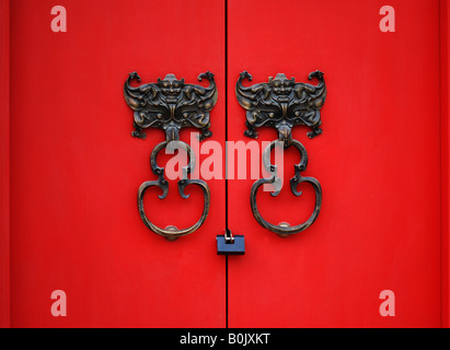 Bat knocker on red door in Beijing,China Stock Photo