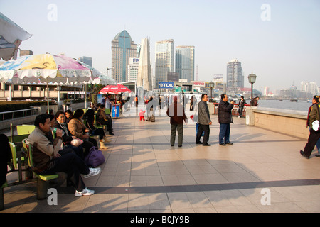 Chinese tourists and sightseers on the Bund in Shanghai. Stock Photo