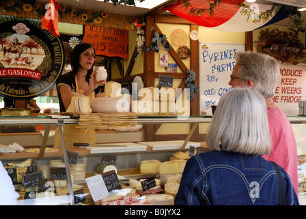 Couple buying cheese from a French market in Plymouth, UK Stock Photo