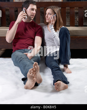 Couple Talking on Mobile Phones Stock Photo