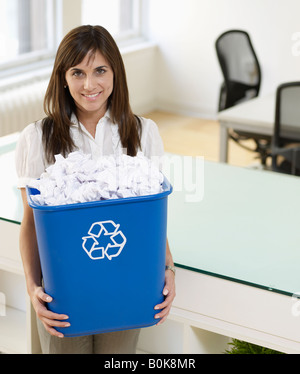 Mid-Adult Woman Holding Paper Recycling Bin Stock Photo