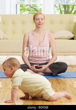 Mother and son doing yoga on beach, California, america, USA Stock