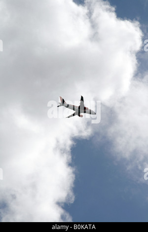 easyjet plane flying through dark clouds in sky Stock Photo