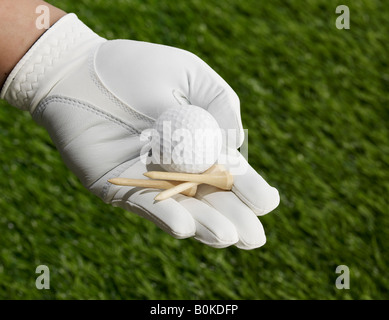 Golf Tees and Ball in Hand Stock Photo