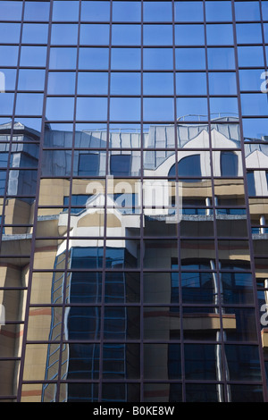 Reflection of modern building in the glass panelled windows of another Glasgow Scotland Stock Photo
