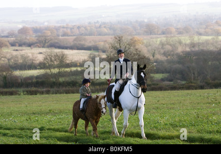 Mother and daughter ride together through rolling hillsides The Cotswolds Oxfordshire United Kingdom